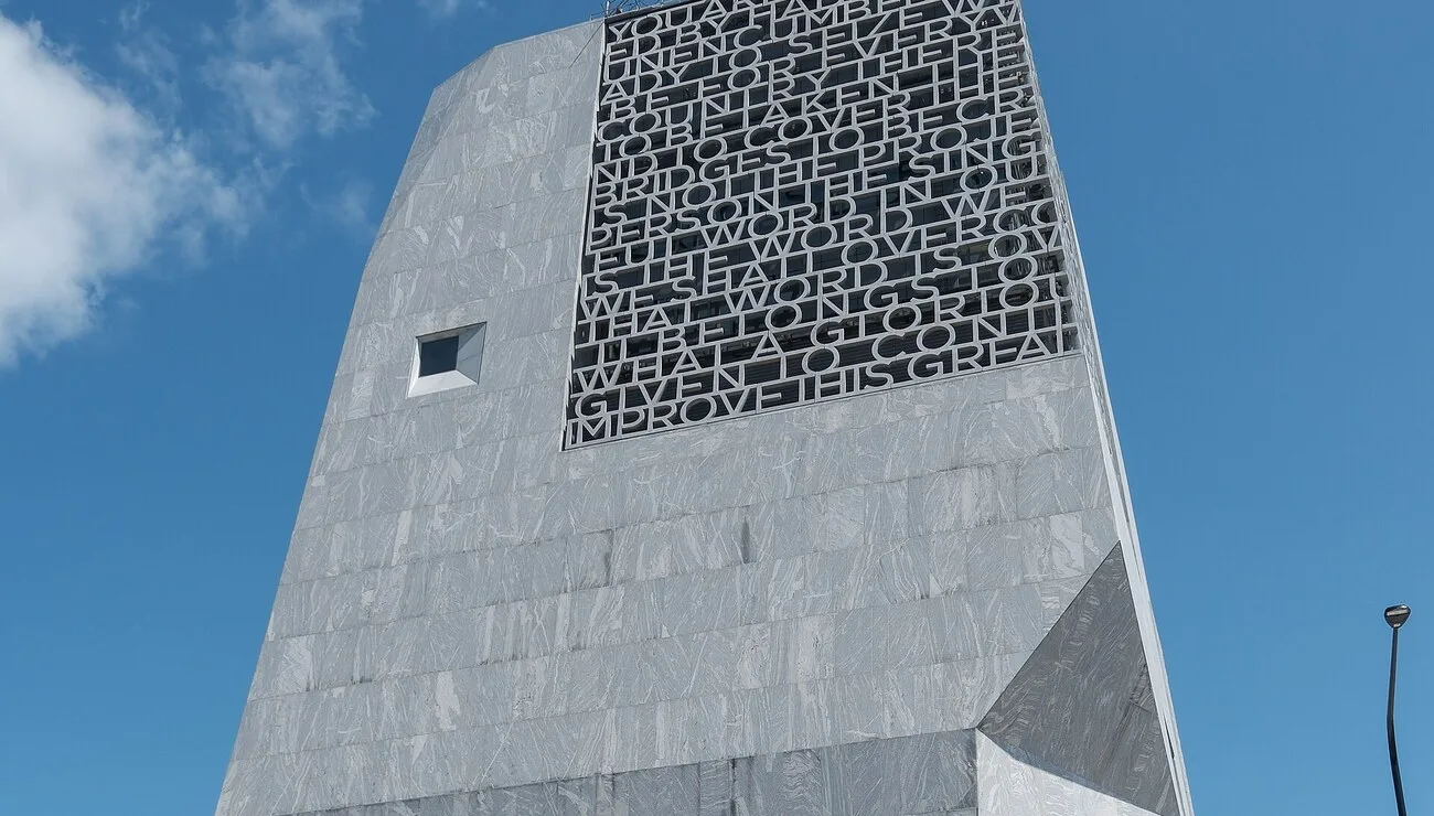 The Barack Obama Presidential Center museum tower with its carved stone lattice in Chicago's Jackson Park, opening on Juneteenth 2026