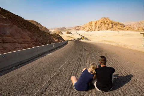 Couple Sitting on Road for a destination guide