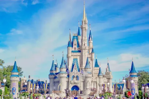 Cinderella Castle with blue spires under a bright sky at Magic Kingdom in Orlando; FL.