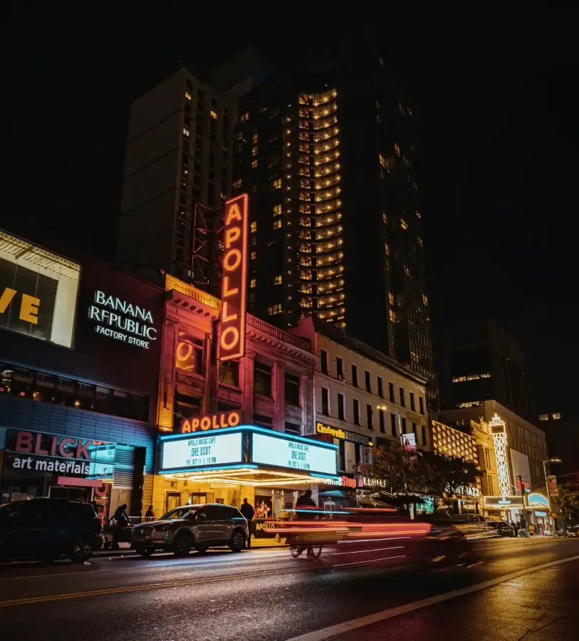 Apollo Theater marquee lit up at night in Harlem New York New York with light trails and neon signage on 125th Street