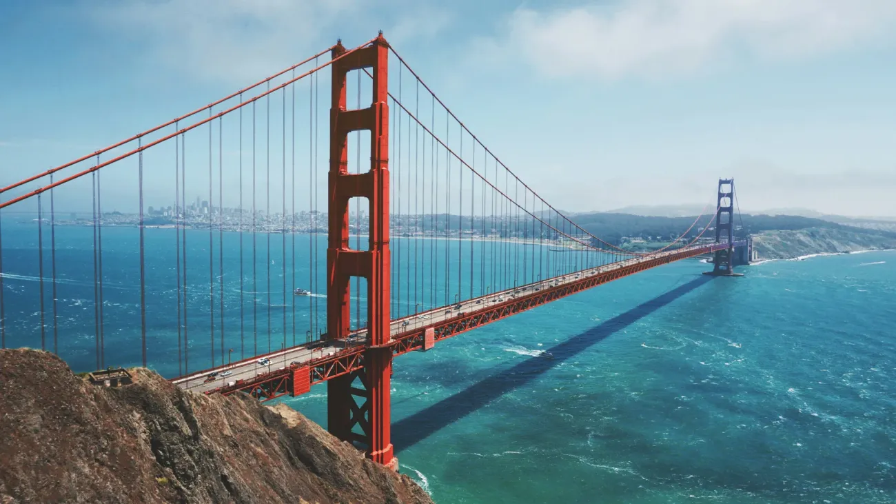 Aerial view of the Golden Gate Bridge spanning San Francisco Bay; CA; with the city skyline visible in the background.