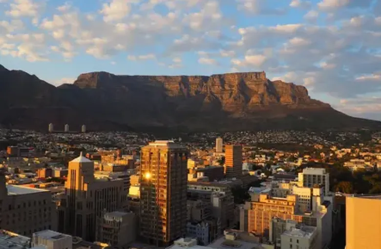 Cape Town South Africa with the iconic flat-topped Table Mountain behind the city and the Atlantic Ocean in the foreground