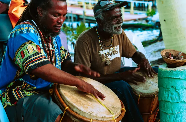 Two men playing Garifuna drums