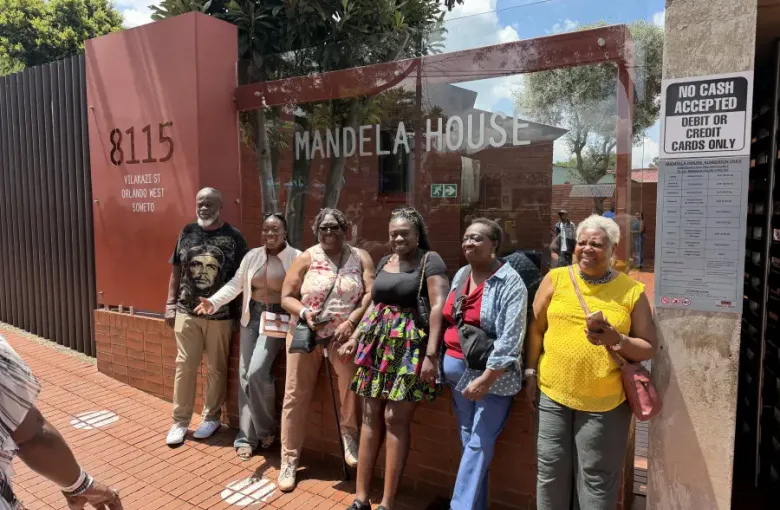 Group of six visitors posing at Mandela House; 8115 Vilakazi St; Orlando West; Soweto; during eat-mea-2026 tour.