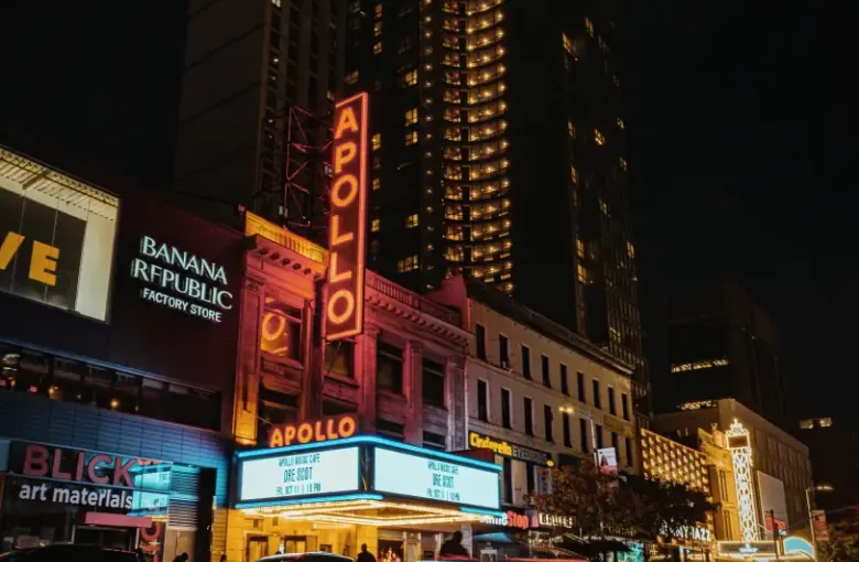 Apollo Theater marquee lit up at night in Harlem New York New York with light trails and neon signage on 125th Street