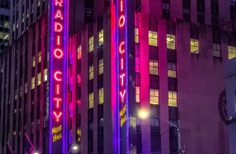 Radio City Music Hall glowing neon marquee at night in New York New York advertising Easy Rider Live Tonight