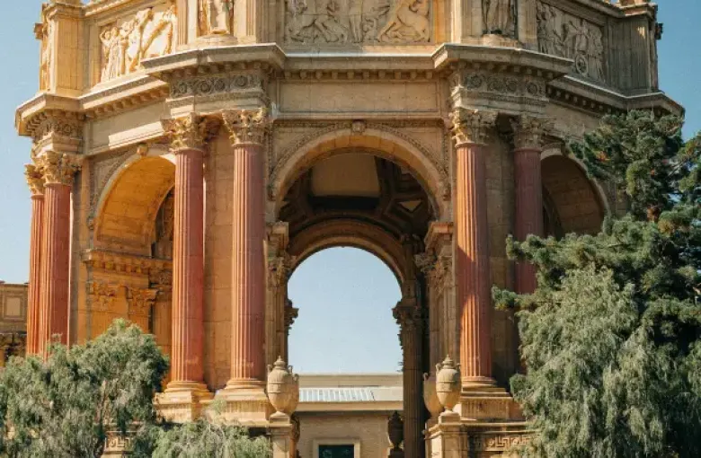 Palace of Fine Arts rotunda with Roman columns and dome reflected in lagoon; San Francisco; CA on a clear sunny day.