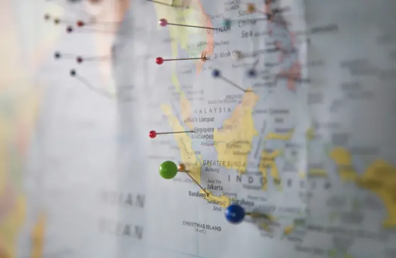 Map of Southeast Asia with colorful pushpins marking travel support destinations including Vietnam; Malaysia; Singapore; a