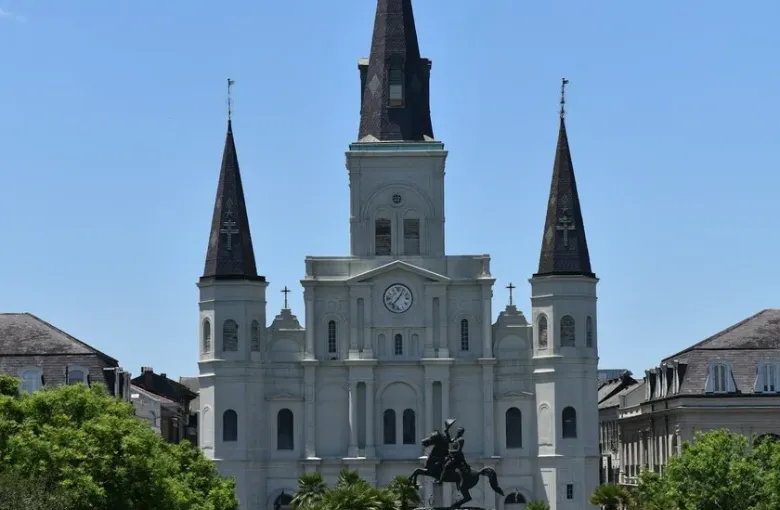 The white spires of St. Louis Cathedral rising above Jackson Square in the New Orleans French Quarter