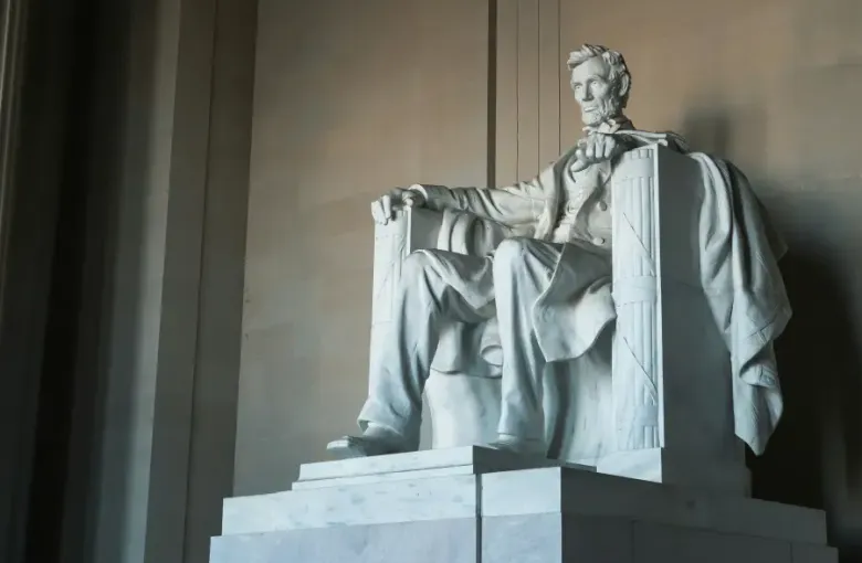 Marble statue of Abraham Lincoln seated at the Lincoln Memorial in Washington; DC; viewed from a low angle.
