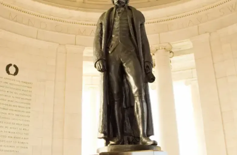 Bronze statue of Thomas Jefferson inside the domed Jefferson Memorial rotunda in Washington; DC; with inscribed quotes on